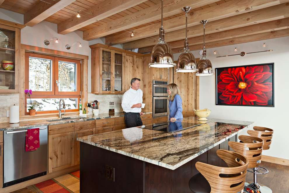 Rustic galley kitchen in Denver with a submerged sink, shaker cabinets, medium wood cabinets, beige splashback, stainless steel appliances, medium hardwood flooring and an island.