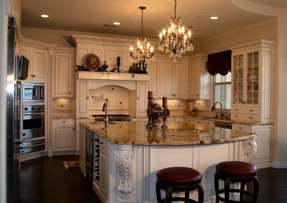 Example of a large french country u-shaped dark wood floor eat-in kitchen design in Albuquerque with a single-bowl sink, recessed-panel cabinets, white cabinets, granite countertops, beige backsplash, ceramic backsplash, stainless steel appliances and an island