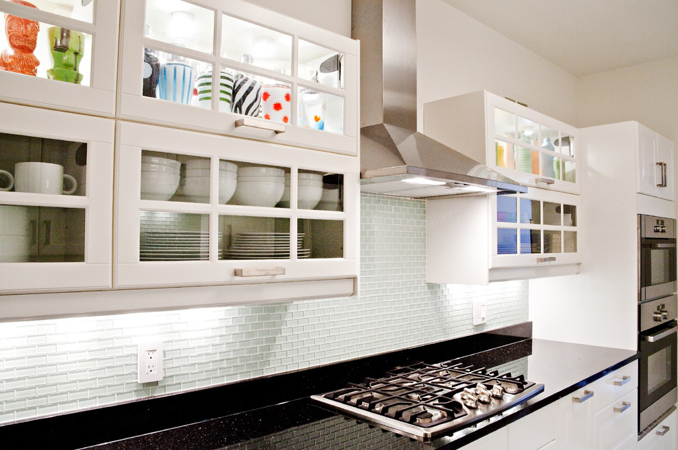 Inspiration för moderna kök, med luckor med glaspanel, vita skåp och granitbänkskiva