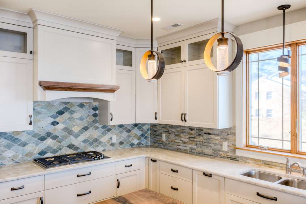 Inspiration for a mid-sized transitional l-shaped light wood floor open concept kitchen remodel in Richmond with a double-bowl sink, white cabinets, limestone countertops, multicolored backsplash, stone tile backsplash, stainless steel appliances and an island