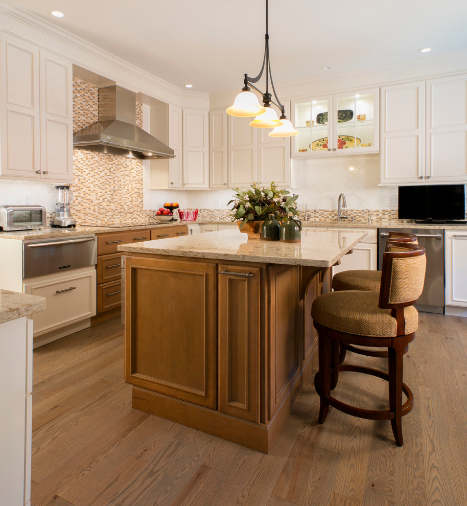 Mid-sized elegant u-shaped medium tone wood floor and brown floor kitchen photo in DC Metro with a double-bowl sink, beaded inset cabinets, white cabinets, granite countertops, beige backsplash, mosaic tile backsplash, stainless steel appliances and an island