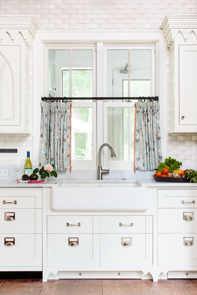 Inspiration for a timeless kitchen remodel in Other with a farmhouse sink, recessed-panel cabinets, white cabinets and beige backsplash