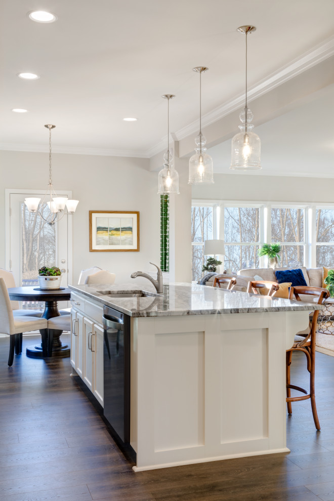 Large elegant single-wall laminate floor and gray floor eat-in kitchen photo in Charlotte with an undermount sink, raised-panel cabinets, white cabinets, granite countertops, white backsplash, subway tile backsplash, stainless steel appliances, an island and gray countertops