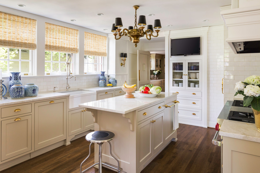 Example of a transitional enclosed kitchen design in Portland with a farmhouse sink, recessed-panel cabinets, beige cabinets, white backsplash and subway tile backsplash