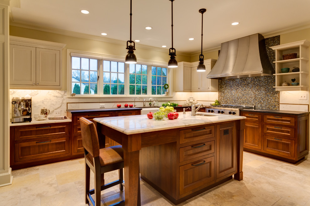 Example of a large classic l-shaped limestone floor eat-in kitchen design in Portland with a farmhouse sink, marble countertops, recessed-panel cabinets, medium tone wood cabinets, stainless steel appliances, white backsplash and stone slab backsplash