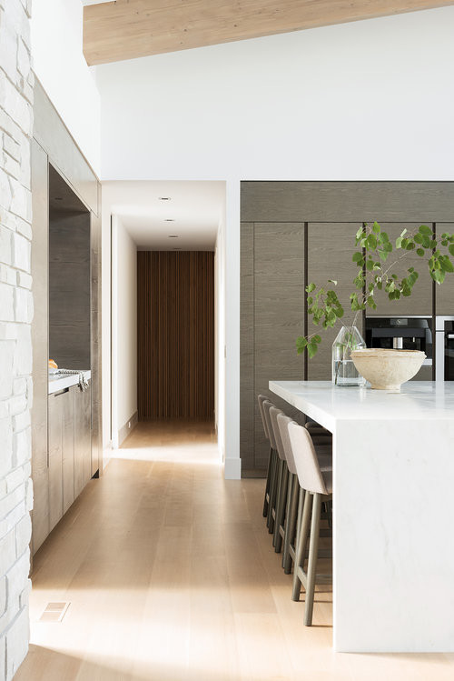 Inspiration for a large modern light wood floor eat-in kitchen remodel in Salt Lake City with dark wood cabinets, multicolored backsplash, marble backsplash, stainless steel appliances, two islands and white countertops