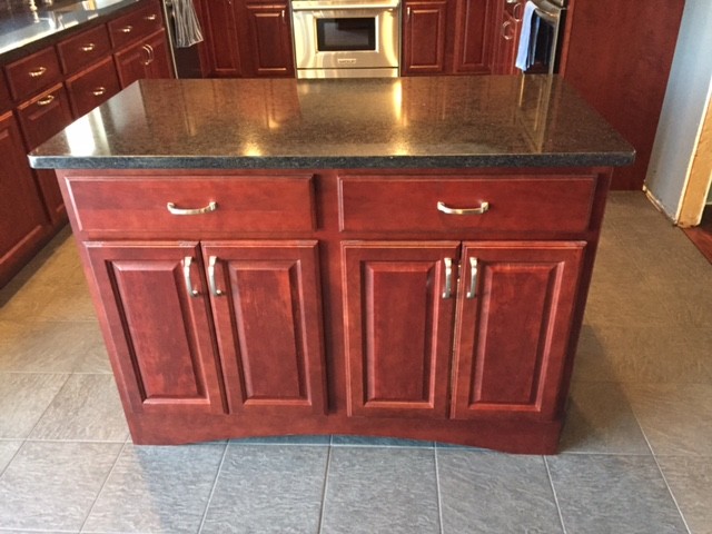 Inspiration for a mid-sized timeless u-shaped porcelain tile enclosed kitchen remodel in Boston with an undermount sink, raised-panel cabinets, red cabinets, quartz countertops, blue backsplash, stainless steel appliances and an island