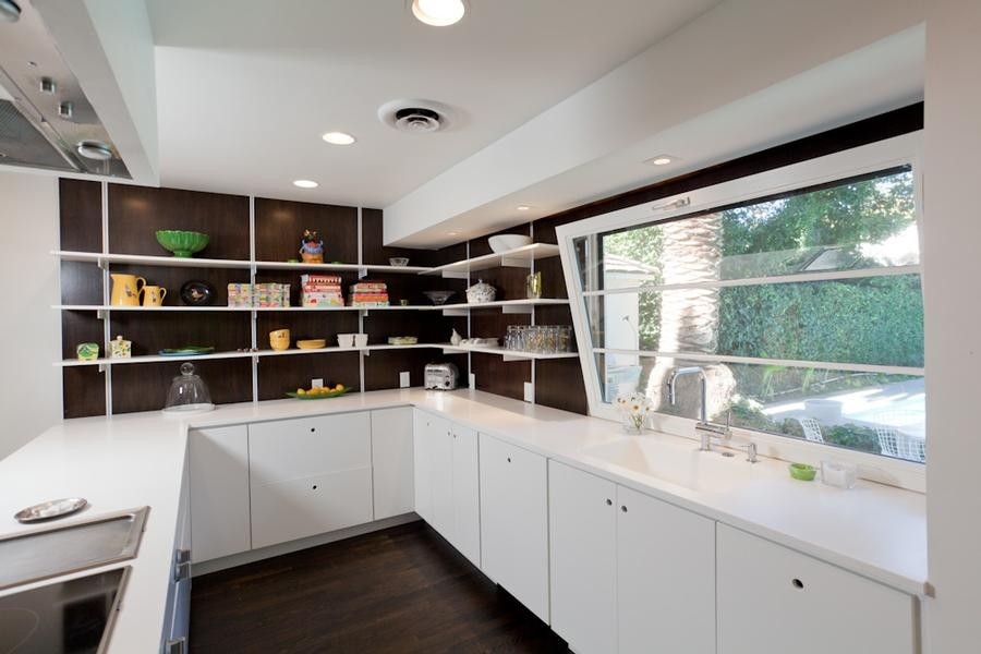 Exempel på ett mellanstort modernt kök, med släta luckor, mörkt trägolv, en halv köksö, en integrerad diskho, brunt stänkskydd, rostfria vitvaror, vita skåp och bänkskiva i koppar