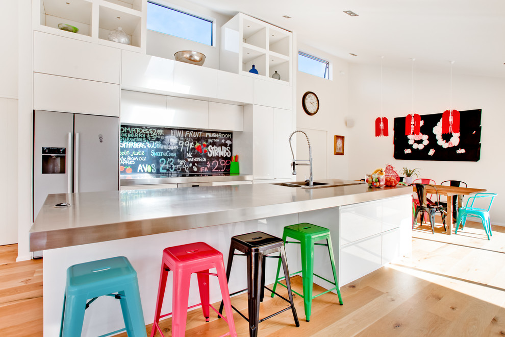 Photo of a contemporary kitchen in Auckland with flat-panel cabinets and stainless steel appliances.