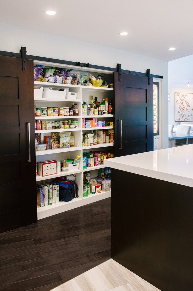 Eat-in kitchen - mid-sized contemporary l-shaped porcelain tile eat-in kitchen idea in Tampa with a farmhouse sink, flat-panel cabinets, dark wood cabinets, quartz countertops, stainless steel appliances and an island