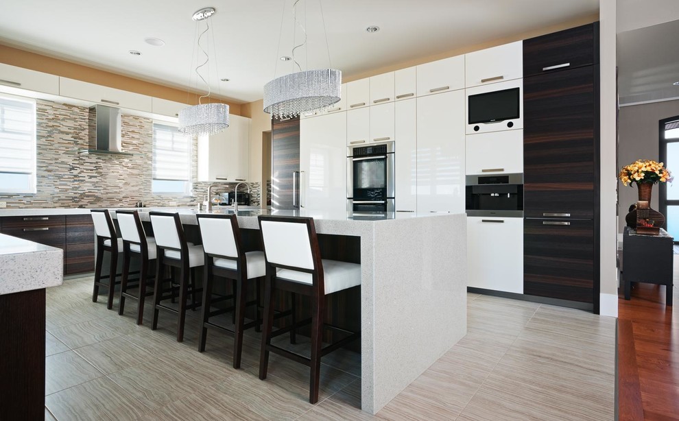 Contemporary u-shaped enclosed kitchen in Calgary with a submerged sink, flat-panel cabinets, white cabinets, engineered stone countertops, metallic splashback and integrated appliances.