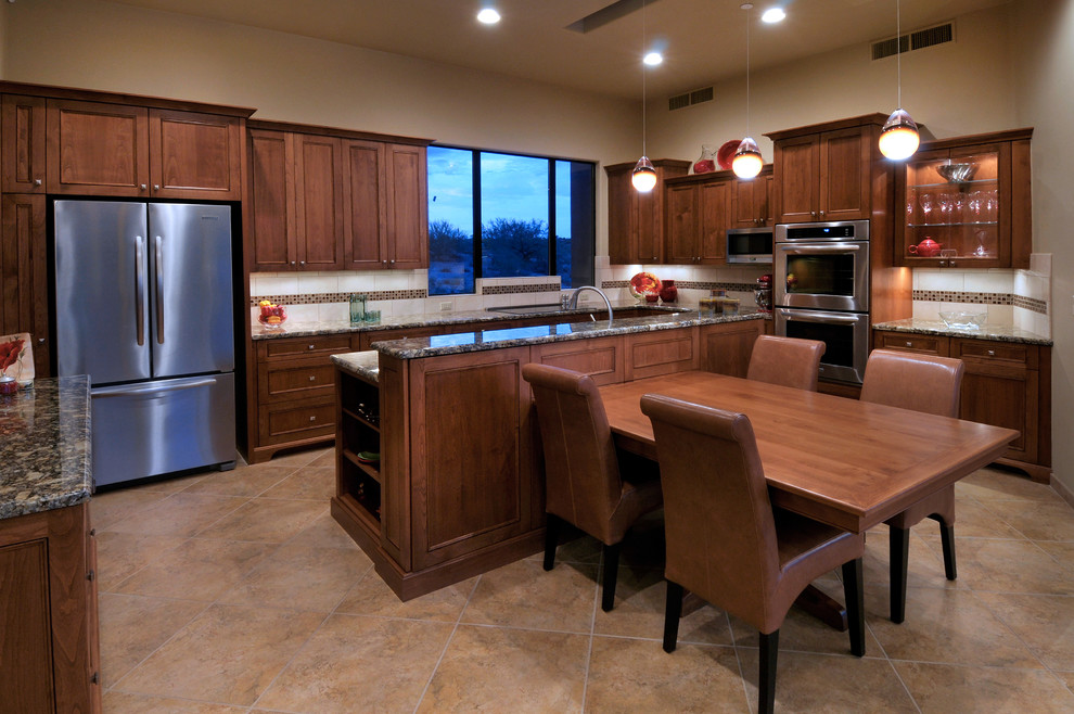 Photo of a contemporary kitchen in Phoenix with glass-front cabinets and stainless steel appliances.