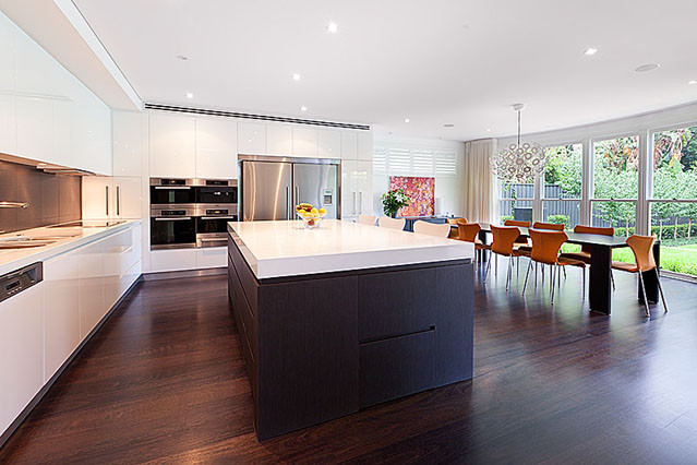 Open concept kitchen - large modern l-shaped dark wood floor open concept kitchen idea in Sydney with an undermount sink, flat-panel cabinets, white cabinets and an island