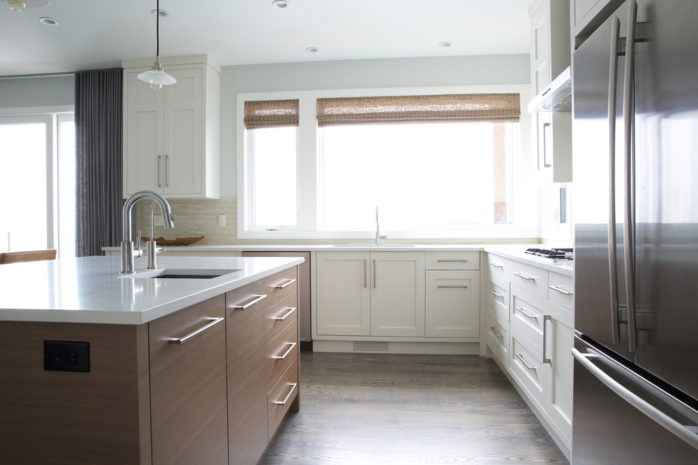Inspiration for a mid-sized contemporary l-shaped vinyl floor and brown floor open concept kitchen remodel in Calgary with an undermount sink, shaker cabinets, white cabinets, quartzite countertops, stainless steel appliances, an island and beige backsplash
