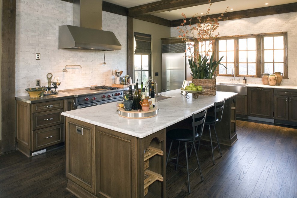 Kitchen - traditional l-shaped kitchen idea in Birmingham with a farmhouse sink, dark wood cabinets, white backsplash, stainless steel appliances and marble backsplash