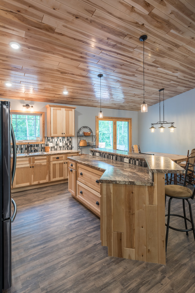 Mid-sized mountain style l-shaped vinyl floor and brown floor eat-in kitchen photo in Minneapolis with an undermount sink, shaker cabinets, light wood cabinets, laminate countertops, multicolored backsplash, mosaic tile backsplash, stainless steel appliances, an island and multicolored countertops