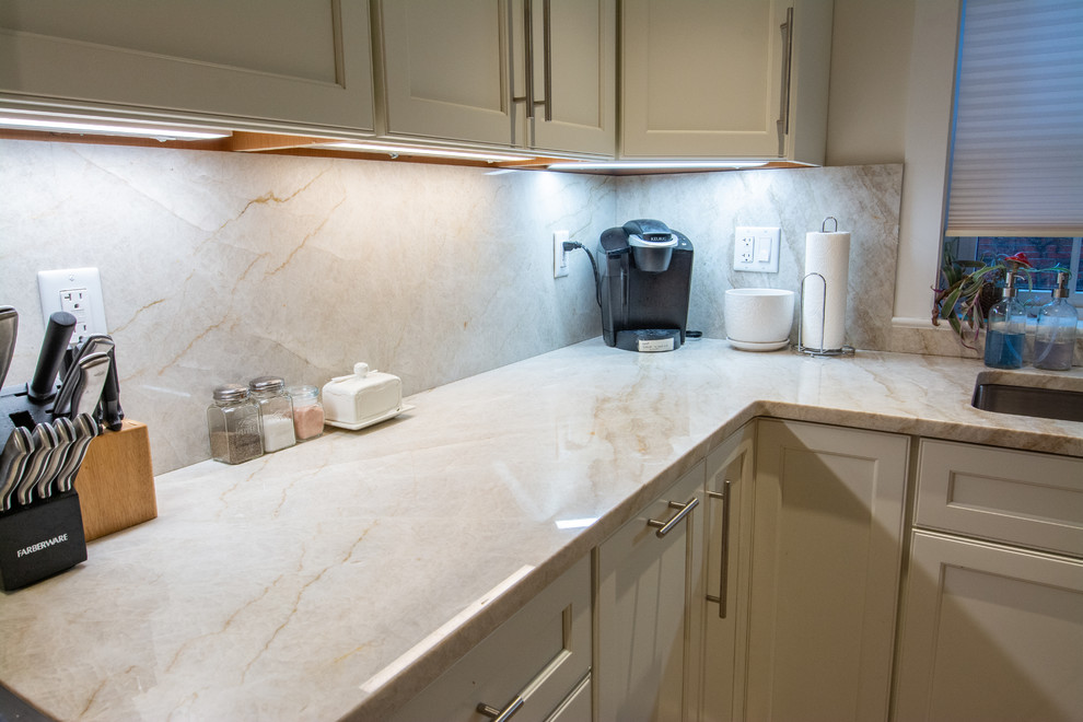 Mid-sized elegant l-shaped eat-in kitchen photo in Boston with an undermount sink and quartzite countertops