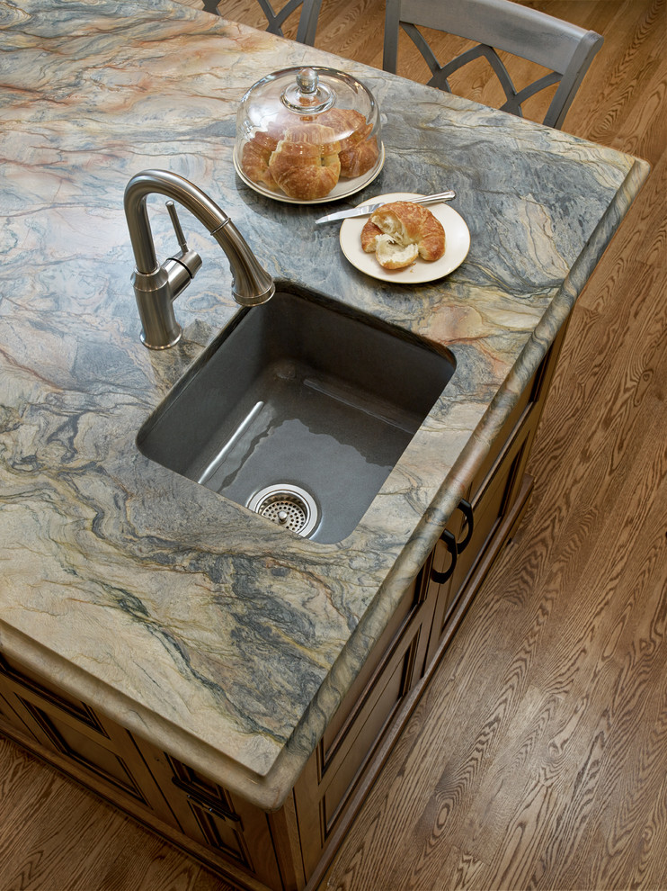 Inspiration for a large transitional u-shaped medium tone wood floor eat-in kitchen remodel in Milwaukee with an undermount sink, quartzite countertops, beige backsplash, ceramic backsplash, stainless steel appliances, an island, shaker cabinets and dark wood cabinets