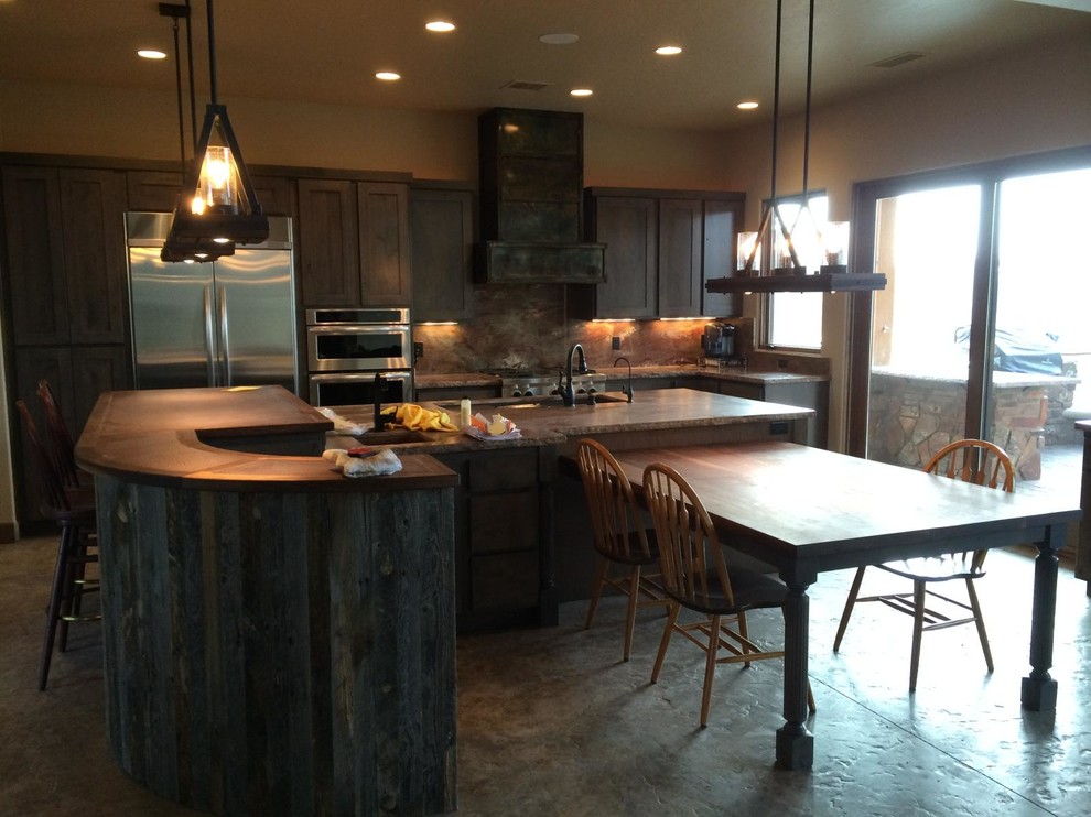 Design ideas for a large rustic u-shaped kitchen/diner in Phoenix with shaker cabinets, grey cabinets, copper worktops, stone slab splashback, stainless steel appliances, concrete flooring and multiple islands.