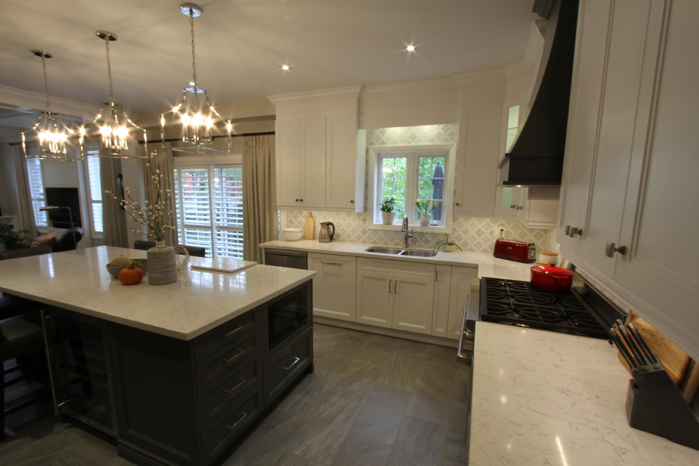 This is an example of a large contemporary u-shaped kitchen/diner in Toronto with a submerged sink, recessed-panel cabinets, white cabinets, engineered stone countertops, grey splashback, mosaic tiled splashback, stainless steel appliances, porcelain flooring, an island, grey floors and white worktops.