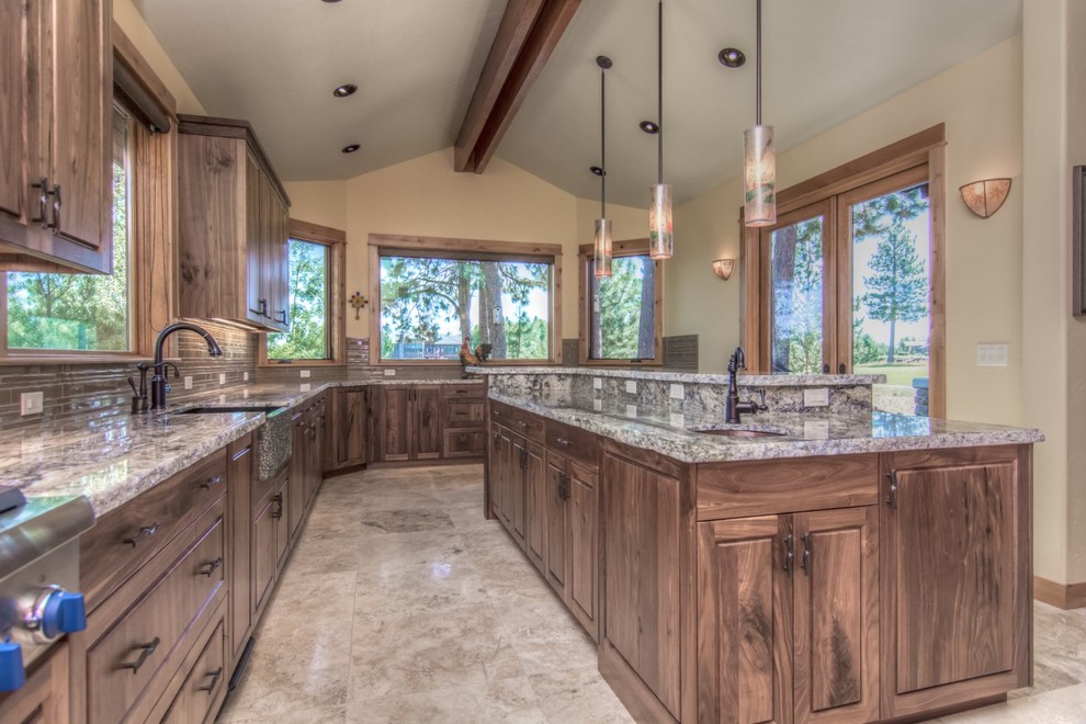Inspiration for a mid-sized rustic l-shaped eat-in kitchen remodel in Other with dark wood cabinets, granite countertops, beige backsplash, stainless steel appliances and an island