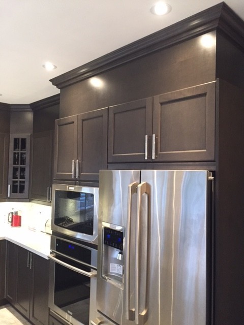 This is an example of a medium sized traditional u-shaped kitchen/diner in Toronto with a submerged sink, shaker cabinets, black cabinets, granite worktops, metallic splashback, mosaic tiled splashback, stainless steel appliances, marble flooring, an island and white floors.