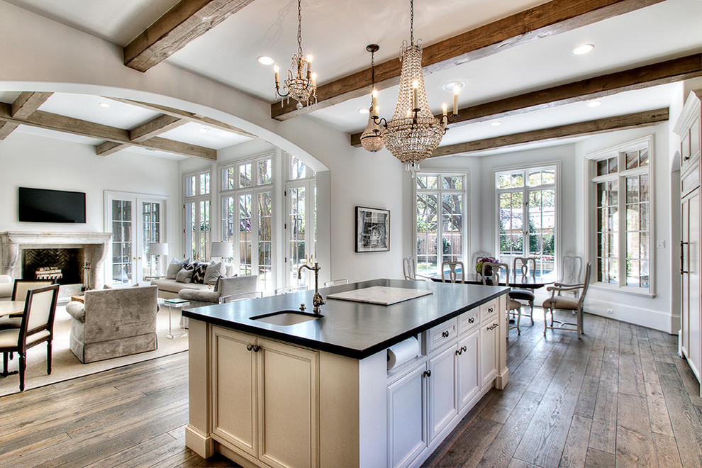 Open concept kitchen - traditional open concept kitchen idea in Houston with a single-bowl sink, recessed-panel cabinets, beige cabinets and black countertops