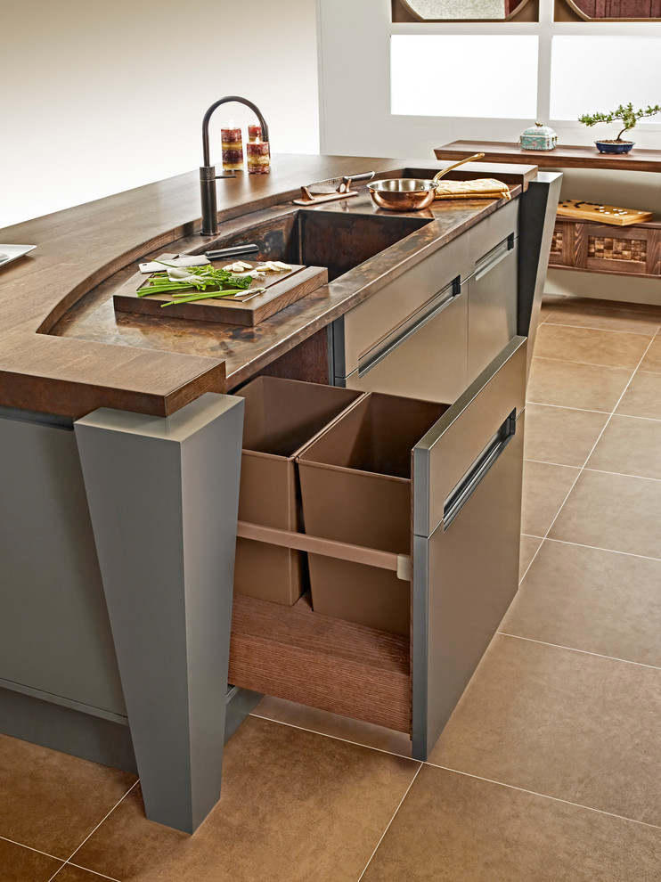 Design ideas for a small world-inspired u-shaped kitchen/diner in Other with a built-in sink, recessed-panel cabinets, light wood cabinets, copper worktops, green splashback, stone slab splashback, black appliances and an island.