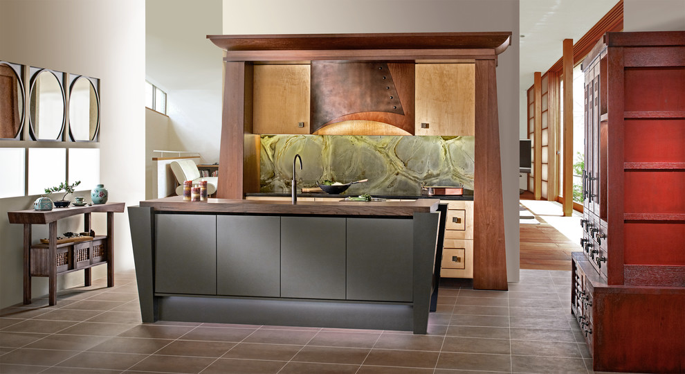 Eat-in kitchen - small asian u-shaped eat-in kitchen idea in Other with a drop-in sink, recessed-panel cabinets, light wood cabinets, green backsplash, stone slab backsplash, black appliances and an island