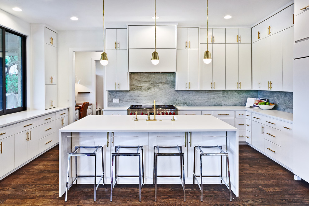 Inspiration for a large contemporary u-shaped dark wood floor and brown floor kitchen remodel in Austin with flat-panel cabinets, white cabinets, quartz countertops, gray backsplash, stone slab backsplash, an island, an undermount sink and stainless steel appliances