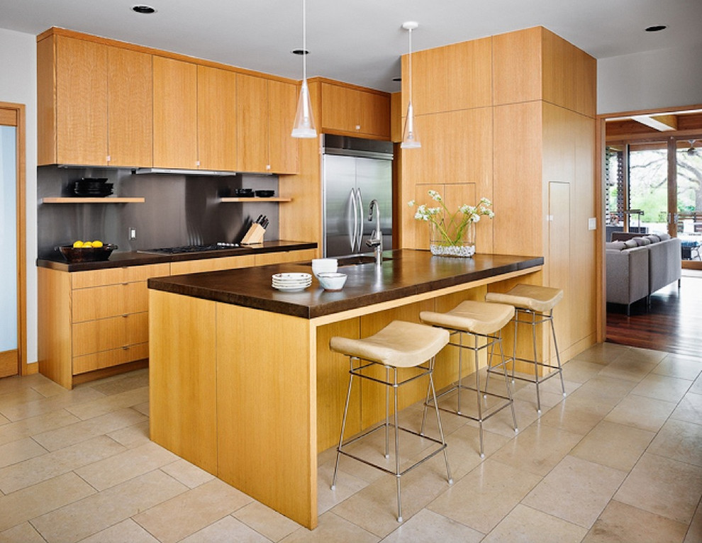 オースティンにあるアジアンスタイルのおしゃれなII型キッチン (シルバーの調理設備、フラットパネル扉のキャビネット、淡色木目調キャビネット、メタリックのキッチンパネル、メタルタイルのキッチンパネル) の写真