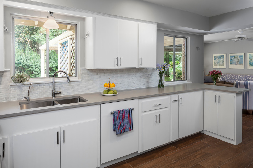 Inspiration for a mid-sized 1950s u-shaped porcelain tile eat-in kitchen remodel in Austin with an undermount sink, flat-panel cabinets, white cabinets, quartz countertops, yellow backsplash, stone tile backsplash, paneled appliances and a peninsula