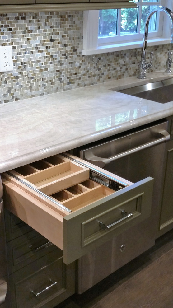 Inspiration for a small transitional l-shaped porcelain tile enclosed kitchen remodel in New York with an undermount sink, recessed-panel cabinets, green cabinets, quartzite countertops, metallic backsplash, glass sheet backsplash, stainless steel appliances and an island