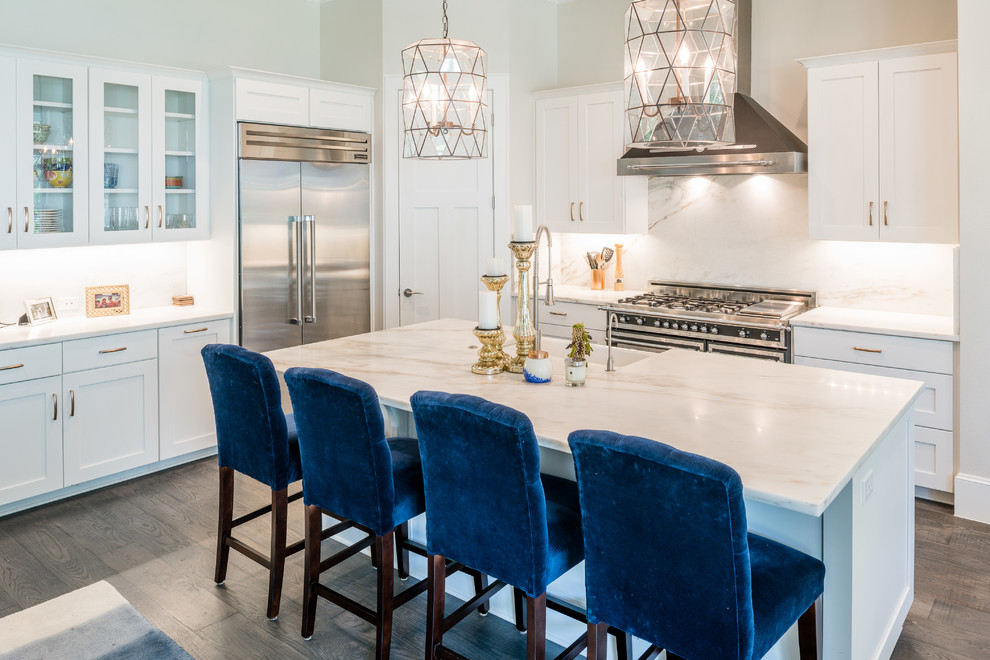 Photo of a medium sized classic l-shaped open plan kitchen in Austin with a single-bowl sink, shaker cabinets, white cabinets, marble worktops, white splashback, stainless steel appliances, dark hardwood flooring and an island.