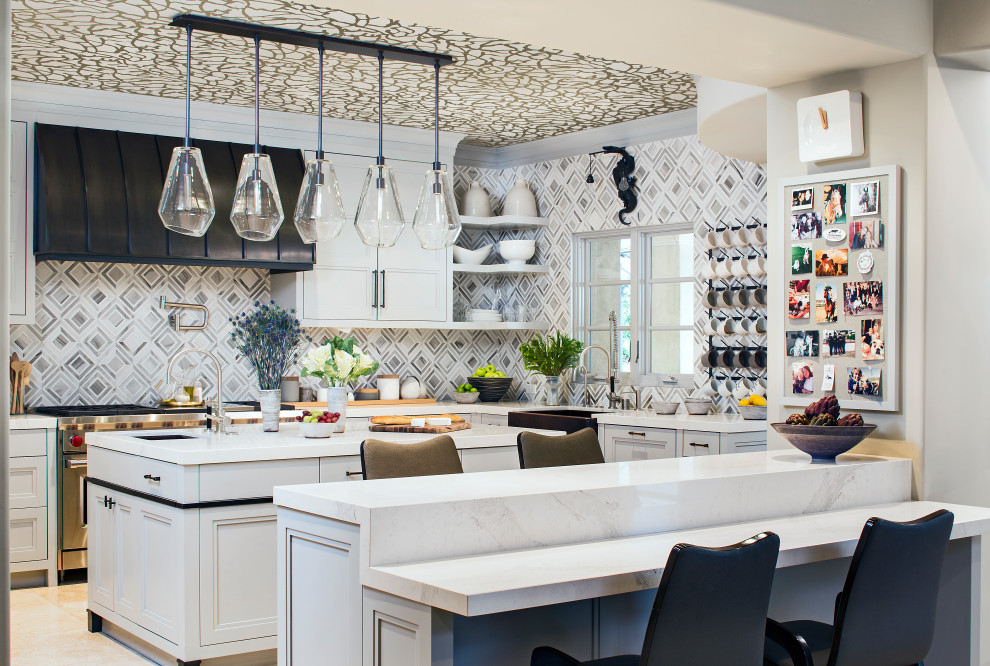 Example of an eclectic u-shaped wallpaper ceiling kitchen design in Los Angeles with a farmhouse sink, recessed-panel cabinets, gray cabinets, multicolored backsplash, stainless steel appliances, two islands and white countertops