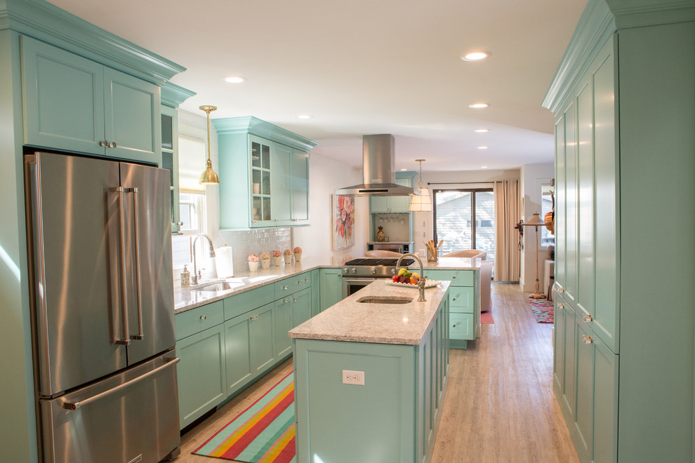 Example of a small beach style l-shaped vinyl floor and gray floor eat-in kitchen design in Other with an undermount sink, flat-panel cabinets, turquoise cabinets, quartz countertops, white backsplash, ceramic backsplash, stainless steel appliances and an island