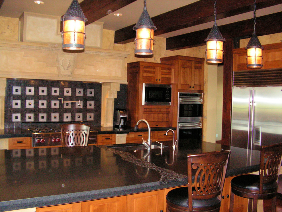Eat-in kitchen - large galley medium tone wood floor eat-in kitchen idea in Other with an undermount sink, raised-panel cabinets, medium tone wood cabinets, soapstone countertops, black backsplash, porcelain backsplash, stainless steel appliances and two islands