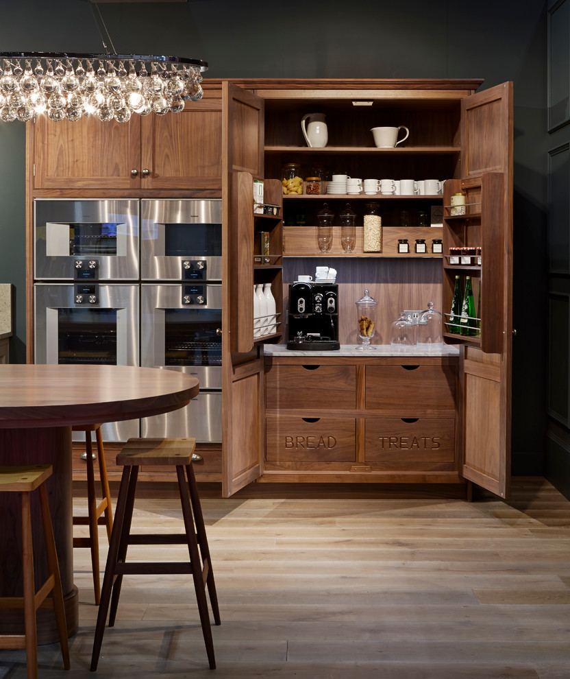 Inspiration for a timeless light wood floor kitchen remodel in Oxfordshire with shaker cabinets, dark wood cabinets and stainless steel appliances