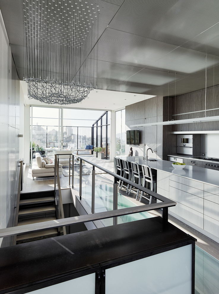 Photo of a contemporary kitchen in San Francisco with flat-panel cabinets and stainless steel appliances.