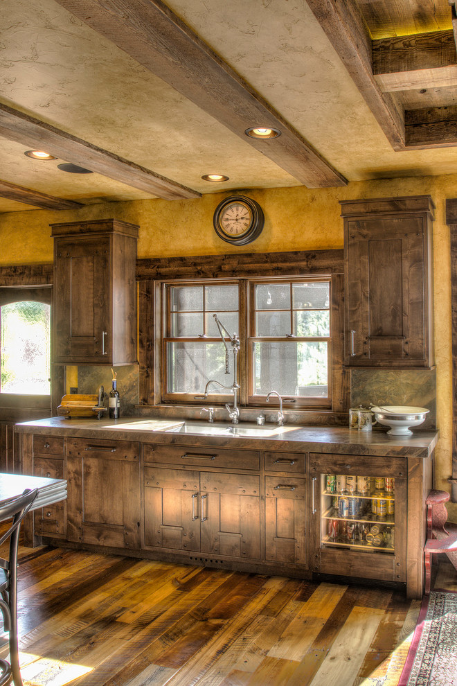 Design ideas for a large rustic l-shaped kitchen/diner in Minneapolis with a submerged sink, flat-panel cabinets, medium wood cabinets, granite worktops, integrated appliances, medium hardwood flooring, an island and multicoloured worktops.