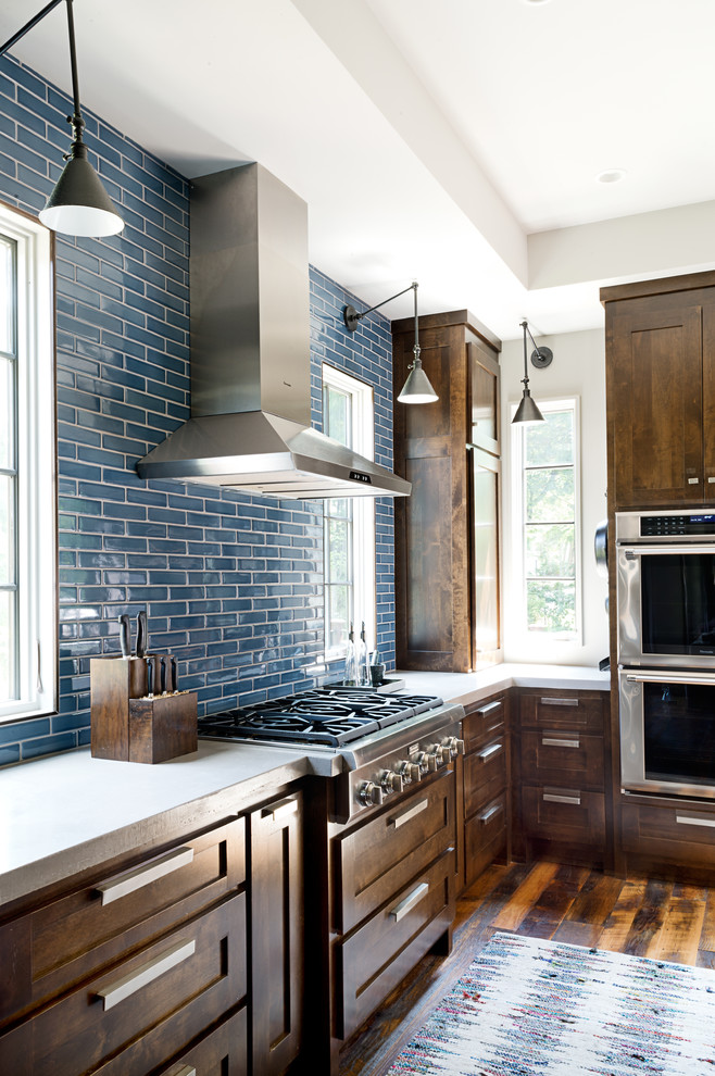 Kitchen - large transitional u-shaped dark wood floor kitchen idea in Other with an undermount sink, shaker cabinets, dark wood cabinets, concrete countertops, blue backsplash, subway tile backsplash, stainless steel appliances and an island