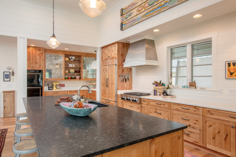 Rural l-shaped kitchen in Other with a submerged sink, shaker cabinets, medium wood cabinets, integrated appliances, medium hardwood flooring, an island and brown floors.
