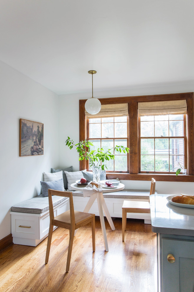 Inspiration for a small transitional l-shaped medium tone wood floor and beige floor eat-in kitchen remodel in Other with a farmhouse sink, recessed-panel cabinets, gray cabinets, quartz countertops, white backsplash, subway tile backsplash, white appliances and a peninsula