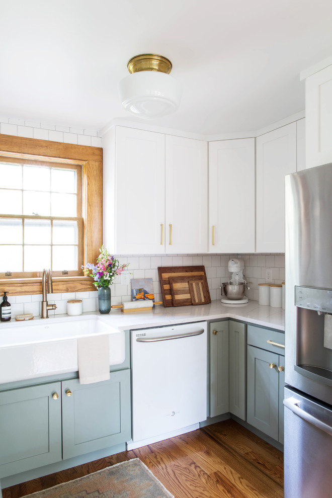 Eat-in kitchen - small transitional l-shaped dark wood floor and brown floor eat-in kitchen idea in Other with a farmhouse sink, recessed-panel cabinets, gray cabinets, white backsplash, subway tile backsplash, white appliances and quartz countertops