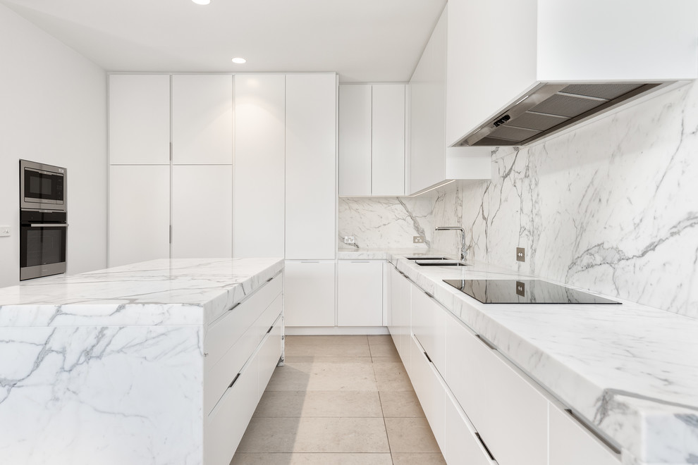 Photo of a medium sized contemporary open plan kitchen in Melbourne with a submerged sink, white cabinets, marble worktops, stone slab splashback, stainless steel appliances, porcelain flooring and an island.