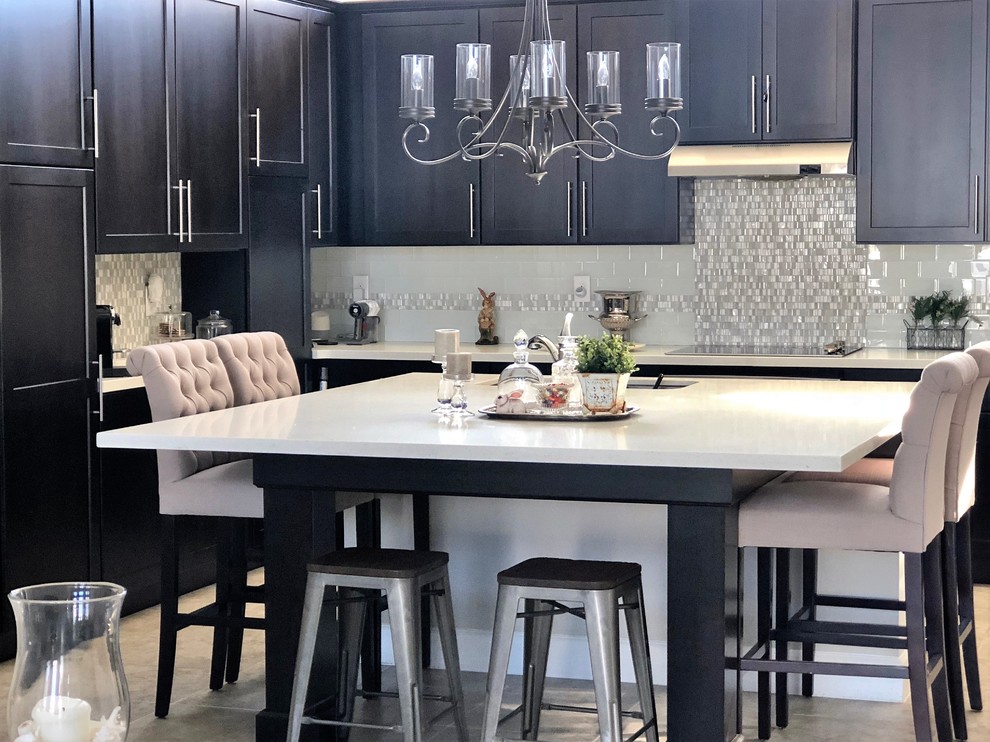 Inspiration for a mid-sized eclectic u-shaped ceramic tile and gray floor open concept kitchen remodel in Orlando with a double-bowl sink, recessed-panel cabinets, dark wood cabinets, quartzite countertops, gray backsplash, mosaic tile backsplash, stainless steel appliances and an island