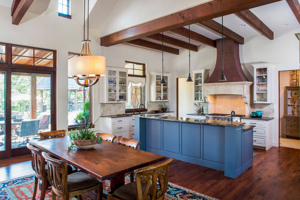 Inspiration for a cottage l-shaped dark wood floor eat-in kitchen remodel in Austin with raised-panel cabinets, white cabinets, beige backsplash, stainless steel appliances and an island