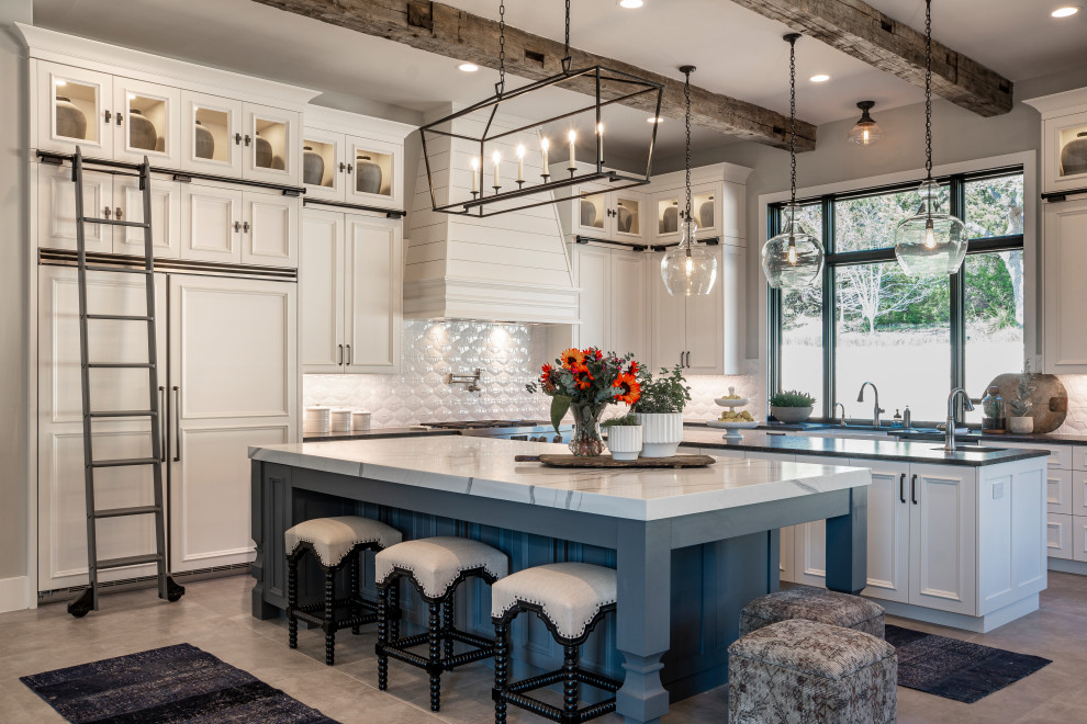 Country l-shaped gray floor kitchen photo with recessed-panel cabinets, white cabinets, white backsplash, paneled appliances, two islands and white countertops