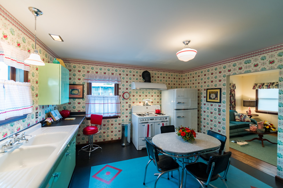 Medium sized retro l-shaped enclosed kitchen in Seattle with a double-bowl sink, louvered cabinets, green cabinets, yellow splashback, lino flooring and no island.