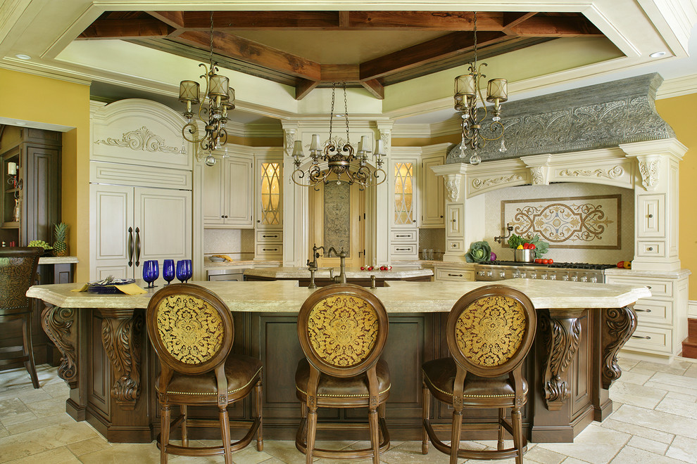 Inspiration for a large timeless l-shaped travertine floor eat-in kitchen remodel in New York with a farmhouse sink, beaded inset cabinets, white cabinets, limestone countertops, beige backsplash, stone tile backsplash, paneled appliances and two islands